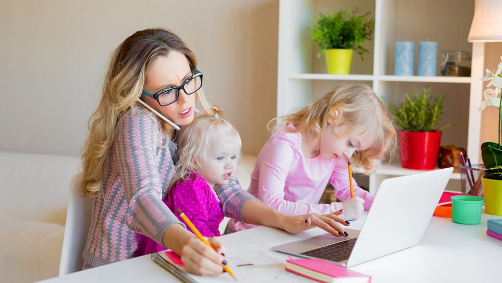 mompreneur life style with kids on the lap and business at hand
